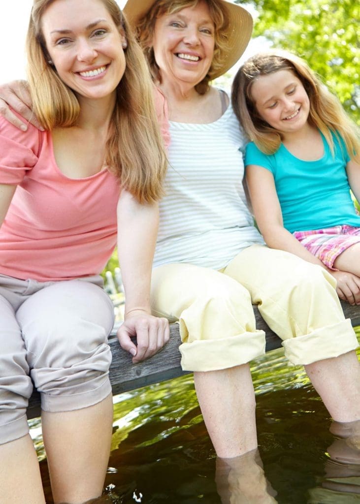  Photo de 3 générations de femmes assises sur un quai