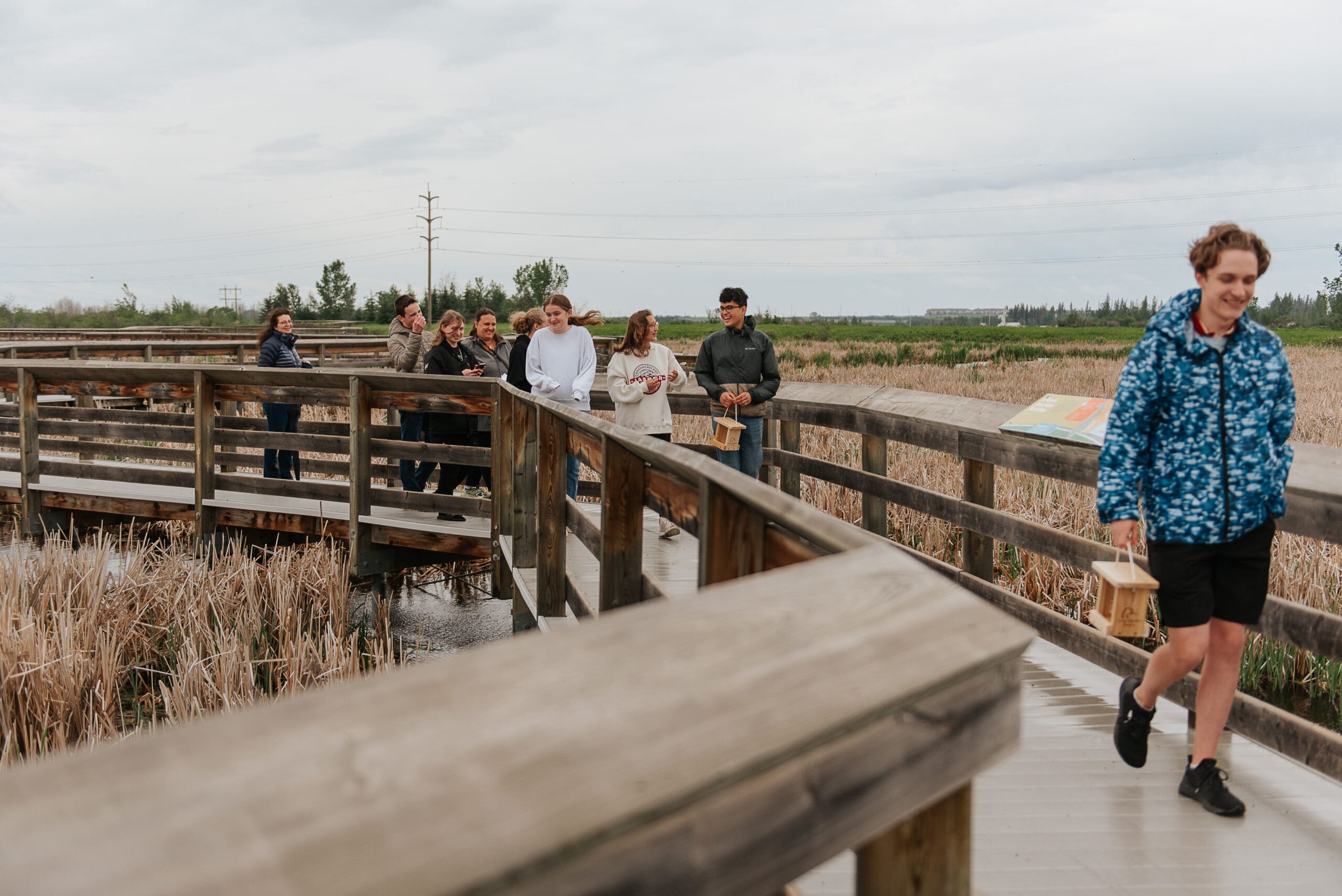 Group of students walking on boardwalk
