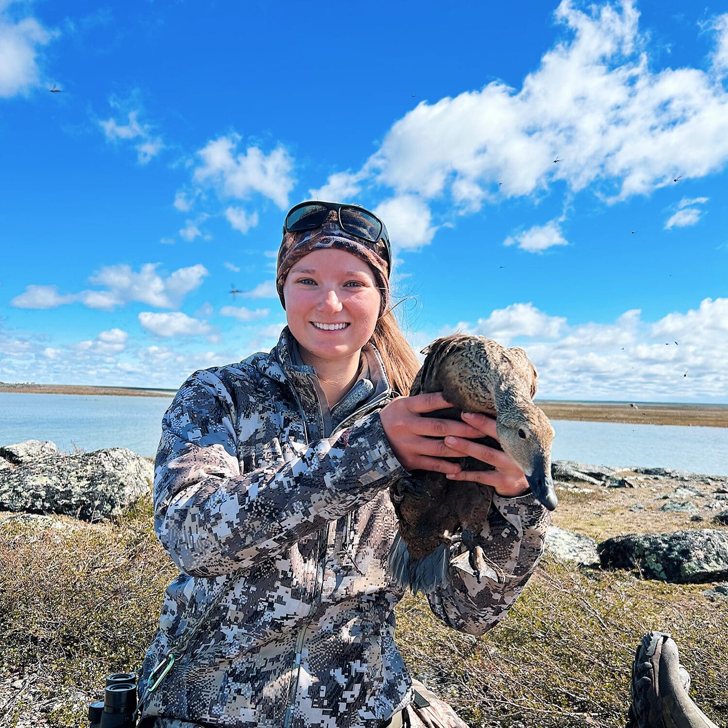 Camryn Vestby, a student researcher, holding a duck