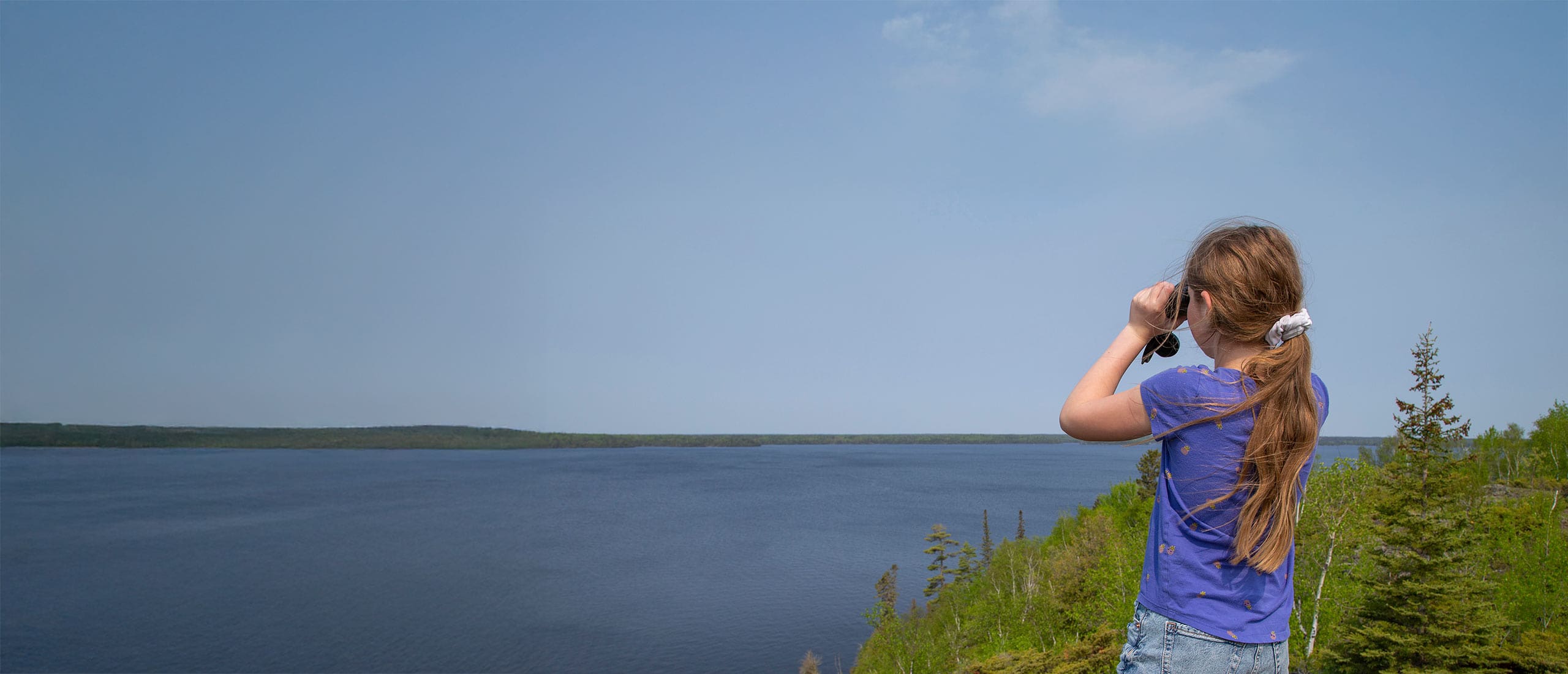 A family playing on a dock in fall.