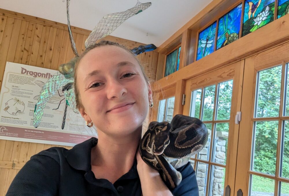 Michaela with a snake at the DUCC on World Snake Day. 